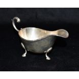A SILVER CREAM JUG With flying scroll handle hallmarked for London 1914 weighing approx. 135.2