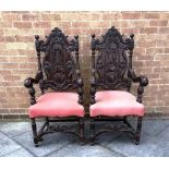 PAIR OF EBONISED CARVED ARMCHAIRS with pink upholstered seats, the backs having carved floral
