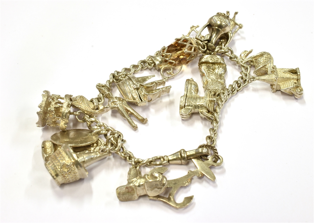 A SILVER AND WHITE METAL CHARM BRACELET weighing 57.6grams - Image 2 of 2