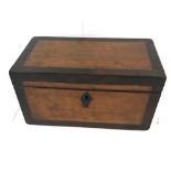 A 19TH CENTURY WALNUT TEA CADDY having an escutcheon to the centre, the hinged top opening to reveal