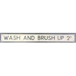 A CAST ALUMINIUM SIGN 'WASH AND BRUSH UP 2D.' with raised black lettering and edging and an off-