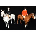 A PAIR OF BESWICK FIGURES: a huntswoman on grey horse model no 1730, huntsman on brown horse model