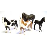 FOUR BESWICK HORSES: a matt finish BlacK Beauty mare and foal, and two 1373 model ponies, one in