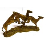 A CAST METAL GROUP OF THREE STYLISED DOGS 32cm wide