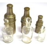 THREE GRADUATED CYLINDRICAL PLATED FLASKS AND COVERS each containing a glass flask with stopper, the