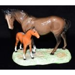 A BESWICK MARE AND FOAL model 953, on oval base, 19cm high