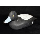 A CARVED AND PAINTED WOODEN DECOY DUCK with glass eyes, 34cm long, signed and dated 'REG CORK