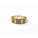 A 9CT GOLD DIAMOND RING the tapered wide band ring set with numerous tiny diamonds on white gold,