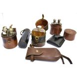 AN ASSORTMENT OF SIX LEATHER CASES to include a circular case for four flasks of which three are