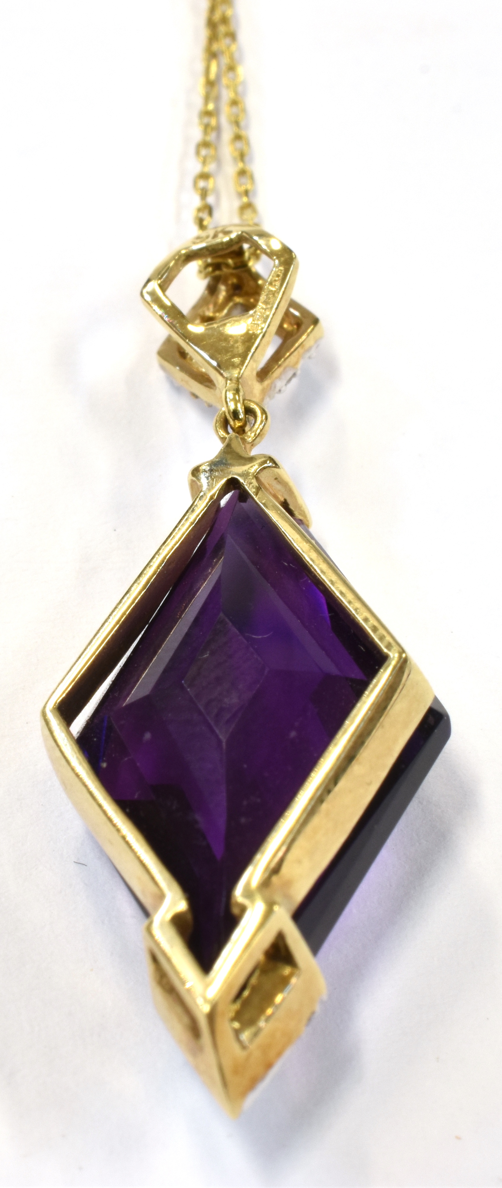 A 9CT GOLD DIAMOND ACCENTED AMETHYST ABSTRACT PENDANT the deep purple amethyst suspended on a tagged - Image 3 of 3