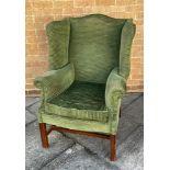 A GREEN UPHOLSTERED WING BACK ARMCHAIR H 107cm