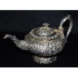 A GEORGE III SILVER TEAPOT The teapot heavily embossed with flowers and Etruscan figures, hallmarked