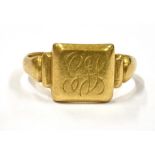 AN 18CT GOLD SIGNET RING with a monogrammed bezel, hallmarked for Birmingham date letter E, ring