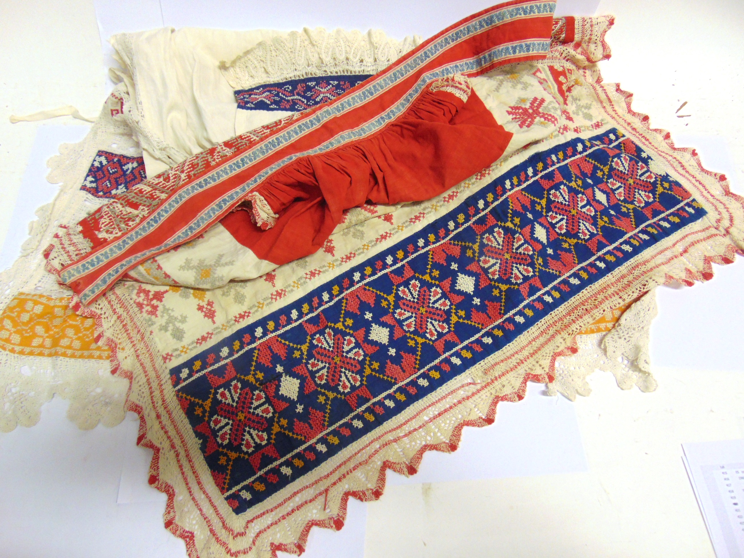 TWO TRADITIONAL EMBROIDERED FOLK APRONS, PROBABLY RUSSIAN early 20th century, one 112cm long, the