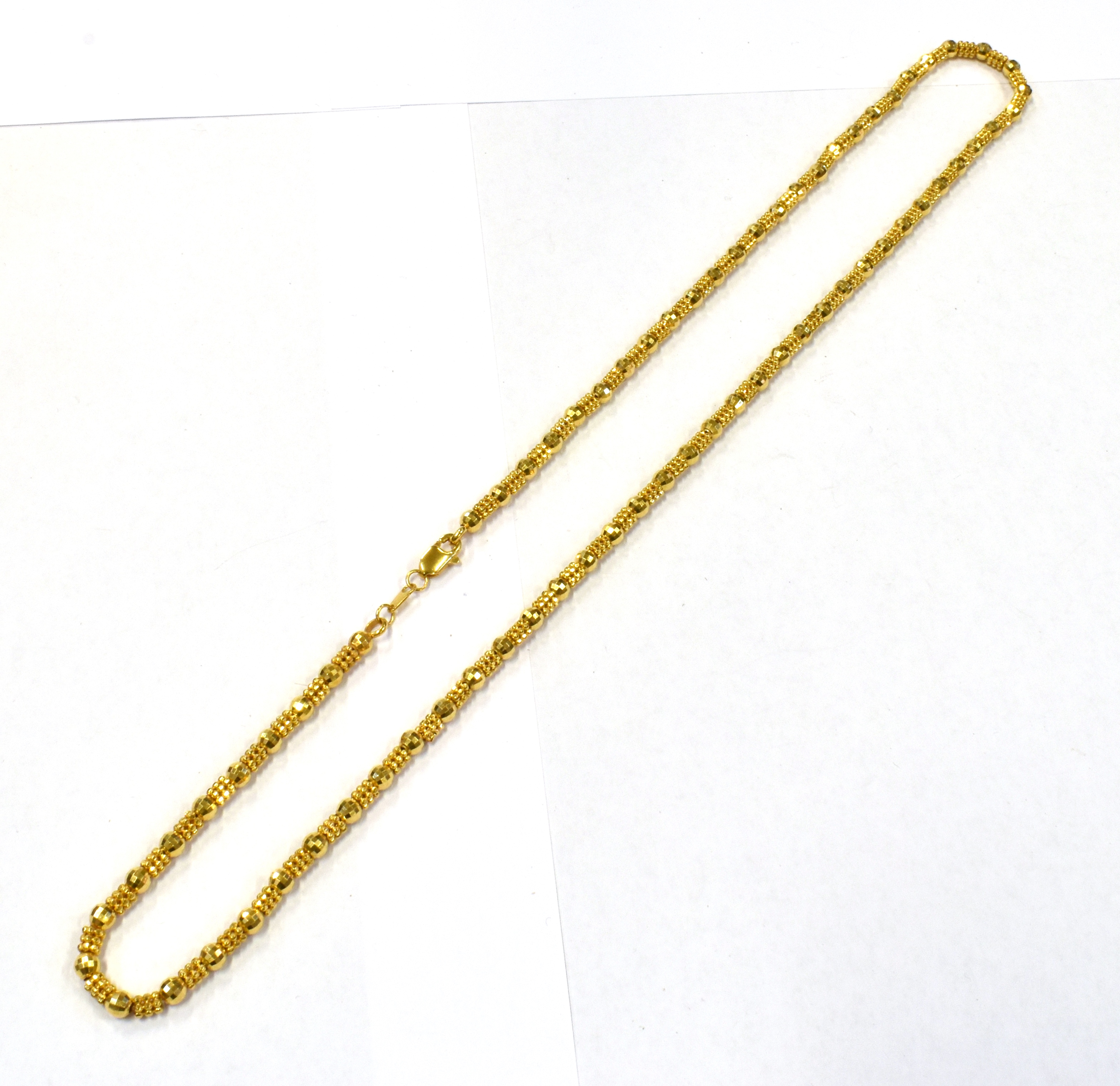 AN ARABIAN GOLD FANCY LINK NECKLACE stamped 21KT, complete with box, necklace length approx. 54cm,