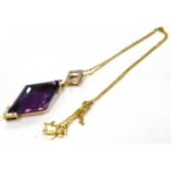 A 9CT GOLD DIAMOND ACCENTED AMETHYST ABSTRACT PENDANT the deep purple amethyst suspended on a tagged