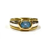 A 9CT GOLD BLUE SPINEL DRESS RING the horizontal set spinel measuring 6mm by 4mm on a yellow gold