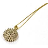 A 9CT GOLD DIAMOND CLUSTER PENDANT the pendant suspended on a marked 375 fine trace link chain,