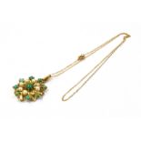 AN EARLY 20TH CENTURY 9CT GOLD TURQUOISE AND SEED PEARL PENDANT BROOCH the openwork starburst