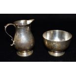 A SILVER CREAMERY JUG Hallmarked for 1975 together with a silver sugar bowl hallmarked for