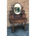 VICTORIAN MAHOGANY DRESSING TABLE having a central mirror raised on scrolled supports, with a