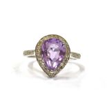 A 9CT WHITE GOLD DIAMOND AND ALMANDINE COCKTAL RING the pear shaped purple almandine measuring