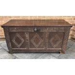 AN OAK COFFER of panelled construction, the front having three panels each with diamond decoration