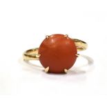 A MARKED 9CT BAMBOO CORAL DRESS RING the cabochon measuring approx. 1.2cm in diameter, ring Q ½