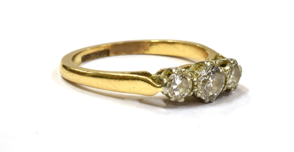 A DIAMOND TRIPLE STONE DRESS RING the three round cut diamonds set on a yellow gold shank with - Image 3 of 3