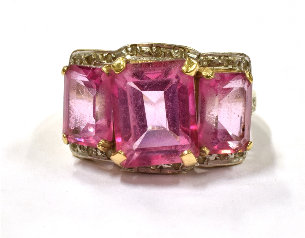 A PINK SPINEL TRIPLE STONE COCKTAIL RING the central spinel measuring approx. 1cm by 0.8cm,