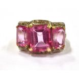 A PINK SPINEL TRIPLE STONE COCKTAIL RING the central spinel measuring approx. 1cm by 0.8cm,