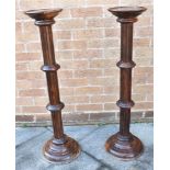 PAIR OF MAHOGANY TORCHERES OR PEDESTALS with circular pie crust top and a circular baluster column