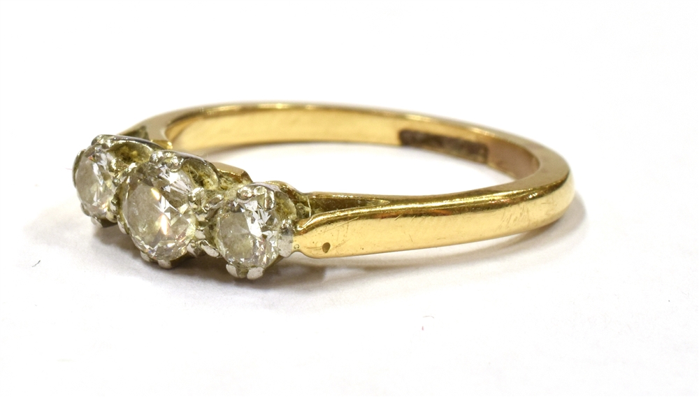 A DIAMOND TRIPLE STONE DRESS RING the three round cut diamonds set on a yellow gold shank with - Image 2 of 3
