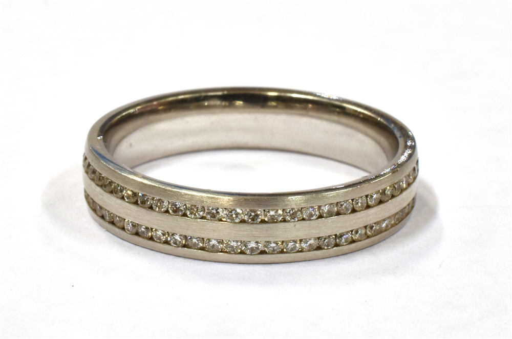 AN 18CT WHITE GOLD, CHANNEL SET DIAMOND ETERNITY RING the ring marked 750 and set with two rows of