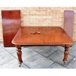 VICTORIAN MAHOGANY EXTENDING DINING TABLE raised on circular legs with casters, and two extra leaves