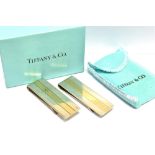 TIFFANY & CO A PAIR OF SILVER AND 18CT GOLD TIFFANY & CO MONEY CLIPS measuring 6cm by 2cm in Tiffany