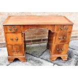 MAHOGANY KEEHOLE DESK the top having a brown leather and gilt insert with three graduating drawers