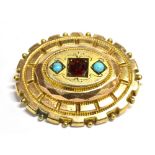 A VICTORIAN YELLOW METAL BROOCH The brooch set with a raised centre set with two Turquoise stones