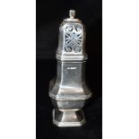 A SILVER SHAKER the shaker with geometric shaped detail, hallmarked for Sheffield 1947, standing