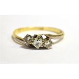 AN 18CT GOLD TRIPLE DIAMOND DRESS RING Marked 18ct to the shank, the round cut diamonds