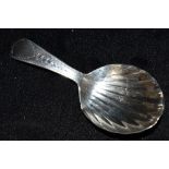 A GEORGE III SILVER BRIGHT CUT CADDY SPOON with shell shaped bowl hallmarked London 1802, 8cm long