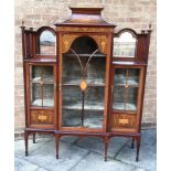 AN EDWARDIAN INLAID BREAKFRONT DISPLAY CABINET the central section having a shaped pediment with