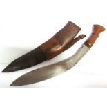 MILITARIA - A KUKRI the 35cm typically curved blade with a hardwood grip, in its leather sheath,