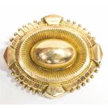 A VICTORIAN YELLOW METAL ETRUSCAN STYLE BROOCH The brooch measuring 3.5cm x 3cm, fitted with a C