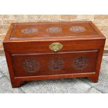 AN ORIENTAL HARDWOOD CHEST with carved decoration to the top, front and to each side, H 61cm x W