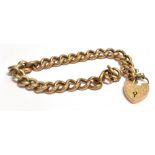 A 9CT ROSE GOLD CURB LINK BRACELET Fitted with a rose gold heart padlock, weight approx. 15.7g.