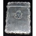 A VICTORIAN SILVER CARD CASE with wavy edges and border, engine patterned body and monogrammed