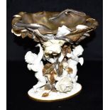 A VICTORIAN MOORE BROS FIGURAL COMPORTE CENTREPIECE modelled as a basket with twin cherub support