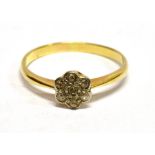 AN ART DECO DAISY DIAMOND RING The 7 small diamonds set in white metal on a yellow metal shank