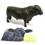 A POTTERY FIGURE OF A DEXTER BULL 39cm long, together with a watercolour of a Dexter by Maureen